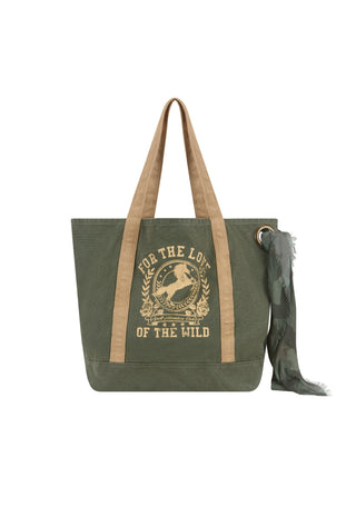 An olive green canvas tote bag with tan shoulder straps and a matching olive green scarf, featuring a tan graphic print on the front with the text 'FOR THE LOVE OF THE WILD'.