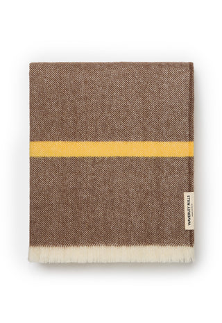 A folded brown woven blanket with a horizontal yellow stripe and a white fringed edge, shown on a clean white background. 